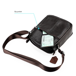 Detail view of dark brown pebbled leather crossbody bag showing functional front zip pocket
