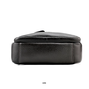 Side view detail of a men's black lychee pattern leather crossbody bag with stitching