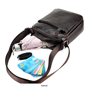 Detailed view of the brown leather messenger bag with multiple interior compartments
