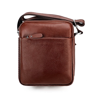 Detail of dark brown leather crossbody bag with litchi texture and silver zipper