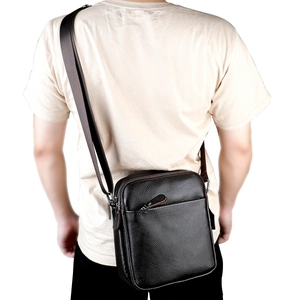 Men's leather crossbody bag with lychee texture and adjustable strap on model