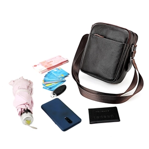Litchi pattern leather crossbody bag for men showing spacious storage capacity and items
