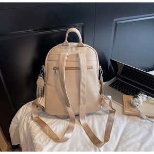 Detailansicht eines cremefarbenen Rucksacks mit Lychee-Struktur und Diebstahlsicherung
