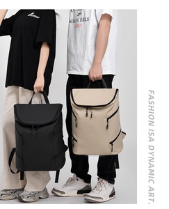 Detail of waterproof matte backpacks in black and beige with leather handles and side zippers