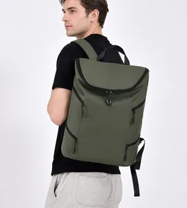 Rear view of olive green waterproof backpack on model highlighting ergonomic straps