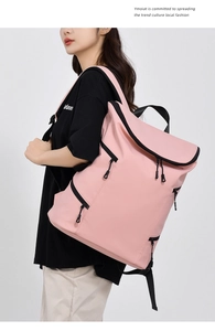Side view of a large capacity pink backpack featuring contrast black zippers for travel