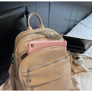 Detailed interior of beige leather backpack showing spacious compartment for a tablet
