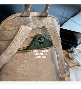Detail of beige leather backpack featuring a secure rear anti-theft zipper pocket for phone