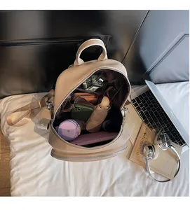 Interior view of beige pebbled leather backpack showing spacious multi-pocket storage capacity
