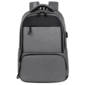 Grey business travel laptop backpack with USB charging port and multi-pocket design
