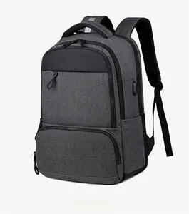 Detail view of the side USB charging port on the durable gray business backpack