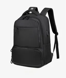 Detail of black business backpack featuring built-in USB charging port and reflective safety strip