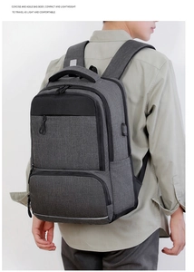 Close-up of gray business backpack featuring a built-in USB charging port for devices