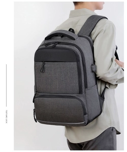 Gray business laptop backpack featuring external USB charging port and anti-theft design