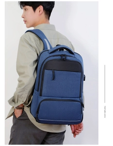 Blue oxford business backpack detail showing USB charging port and padded straps