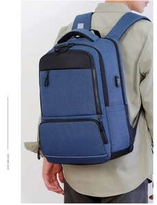 Detail of waterproof business backpack showing external USB port and reflective safety strip