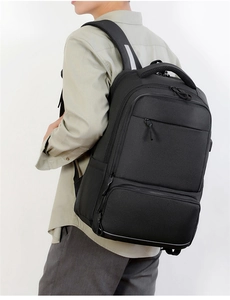 Ergonomic breathable padded shoulder straps on a durable black business laptop backpack