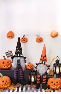 Detail of plush Halloween gnomes with cat ears and pumpkin hats among festive decor
