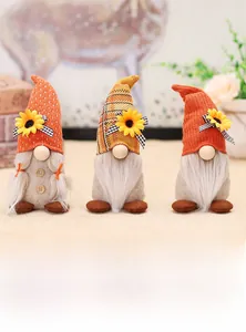 Detail of harvest gnomes with knitted sunflower hats and festive autumn decorations
