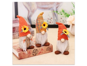 Detailed view of three knitted harvest gnomes with sunflowers and plaid hats for autumn decor
