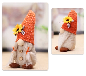 Close-up of autumn gnome doll with sunflower knit hat, braids and wooden buttons