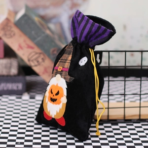 Halloween gnome drawstring gift bag in black velvet with orange pumpkin and purple lining