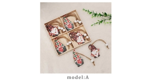 Detail of Christmas wooden gnome ornaments with red and green patterns in a wooden box