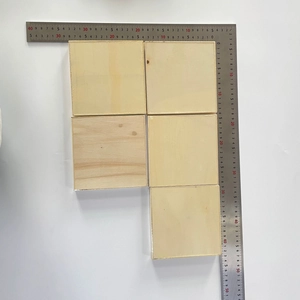 Detailed view of five square 10cm natural wood pieces for Christmas DIY crafts