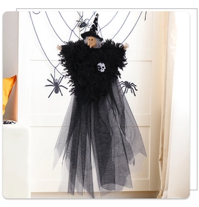 Detail view of Halloween witch hanging decor with mesh skirt and skull detail
