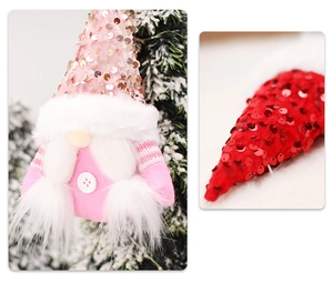 Close-up of sequined Christmas gnome plush ornaments hanging on snowy pine branches