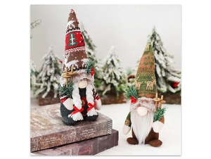 Detail of Christmas gnomes with knitted deer hats holding wooden ski poles in a snowy scene