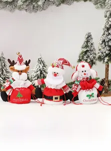 Close-up of knit Christmas drawstring gift bags with Santa, reindeer and snowman details