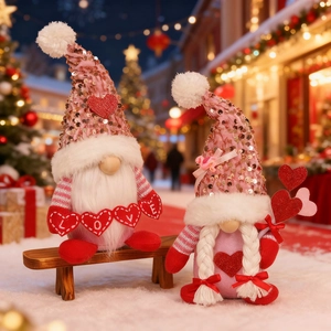 Close-up of Valentine Gnomes with sequins and LOVE hearts on a snowy wooden bench