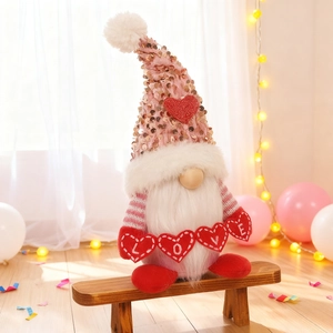 Valentine's Day gnome plush with LOVE hearts on a wooden chair with balloons