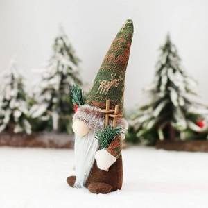 Christmas gnome doll with reindeer knit hat and ski poles for holiday home decoration