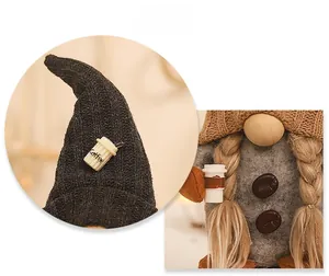 Detail of knitted coffee gnome with coffee cup decor and coffee bean buttons