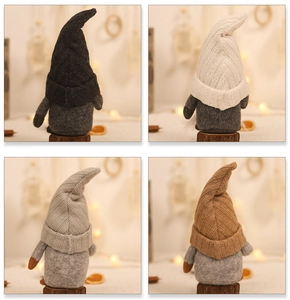 Detail of four knitted gnome plush dolls in black white grey and brown with rustic decor
