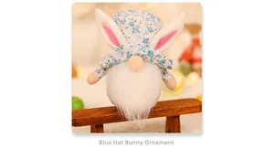 Detail of floral Easter gnome plush with bunny ears and white beard on a wooden bench