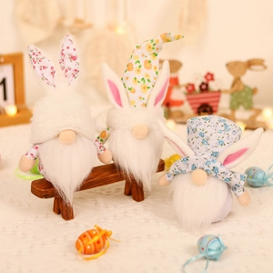 Three Easter gnomes with floral bunny ears and plush beards on a festive warm background