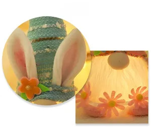 Detail display of Easter bunny plush with glowing lights and knitted blue hat