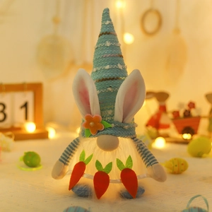 Easter gnome plush with glowing body, blue striped hat, rabbit ears and orange carrots