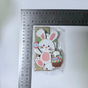 Detailed view of an Easter bunny wooden ornament with dimensions shown on a metal ruler
