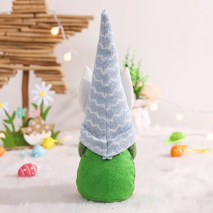 Back view of a knit Easter gnome plush with blue striped hat and rabbit ears decor
