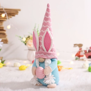 Detail of Easter gnome plush with pink rabbit ears holding a striped egg on a white rug