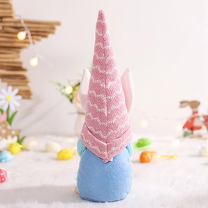 Detail of pink knitted hat and light blue felt body on a cute Easter gnome figurine