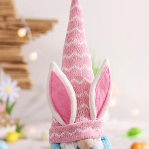 Detailed close-up of a handmade Easter gnome with pink knit hat and plush bunny ears