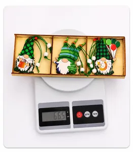 Three St. Patrick's Day wooden gnome ornaments displayed on a digital scale weighing 66.5g