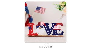 Detail of wooden LOVE sign with gnome and US flag motifs for Independence Day desktop decor