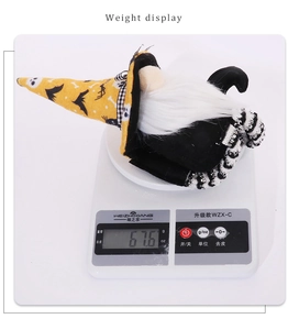 Detailed view of Halloween gnome plush toy on scale showing weight of 67.6 grams