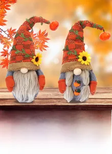 Detail of harvest gnomes with orange knit hats featuring sunflowers and small pumpkins